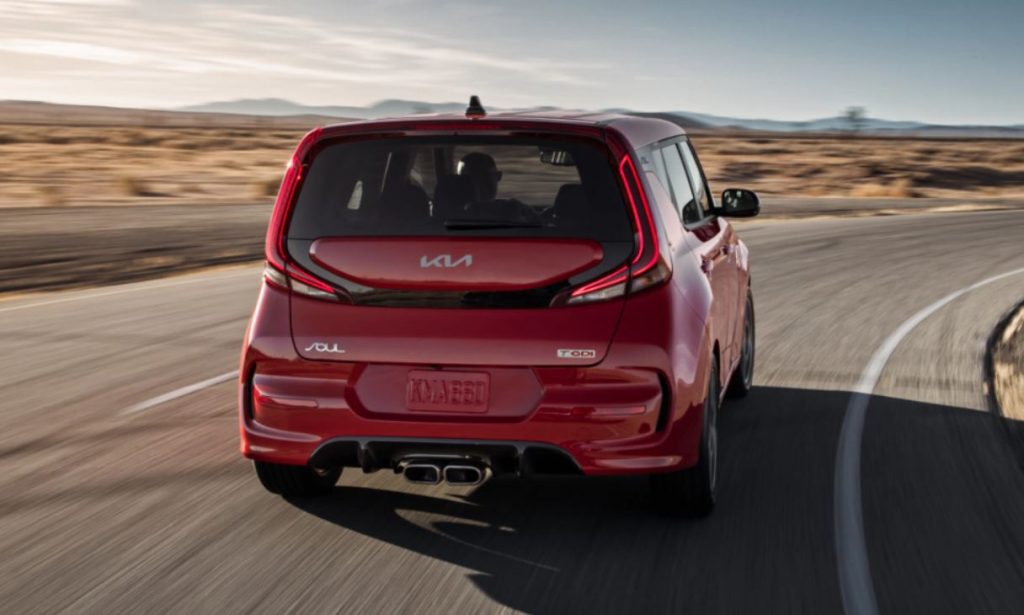 Rear view of a red 2022 Kia Soul being driven on the highway. | Kia dealer in Bentonville, AR