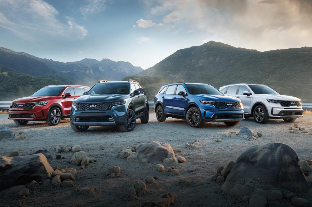 4 2022 Kia Sorentos parked on rocky terrain with mountains in the background. | Kia dealer in Bentonville, AR.