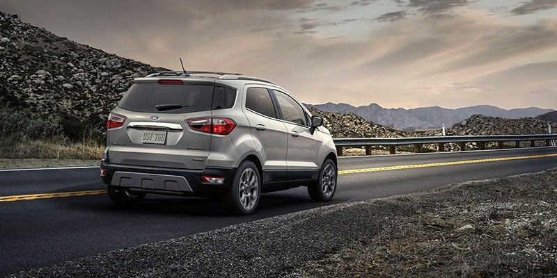 A silver 2021 Kia EcoSport parked on the road. | Kia dealer in Bentonville, AR.